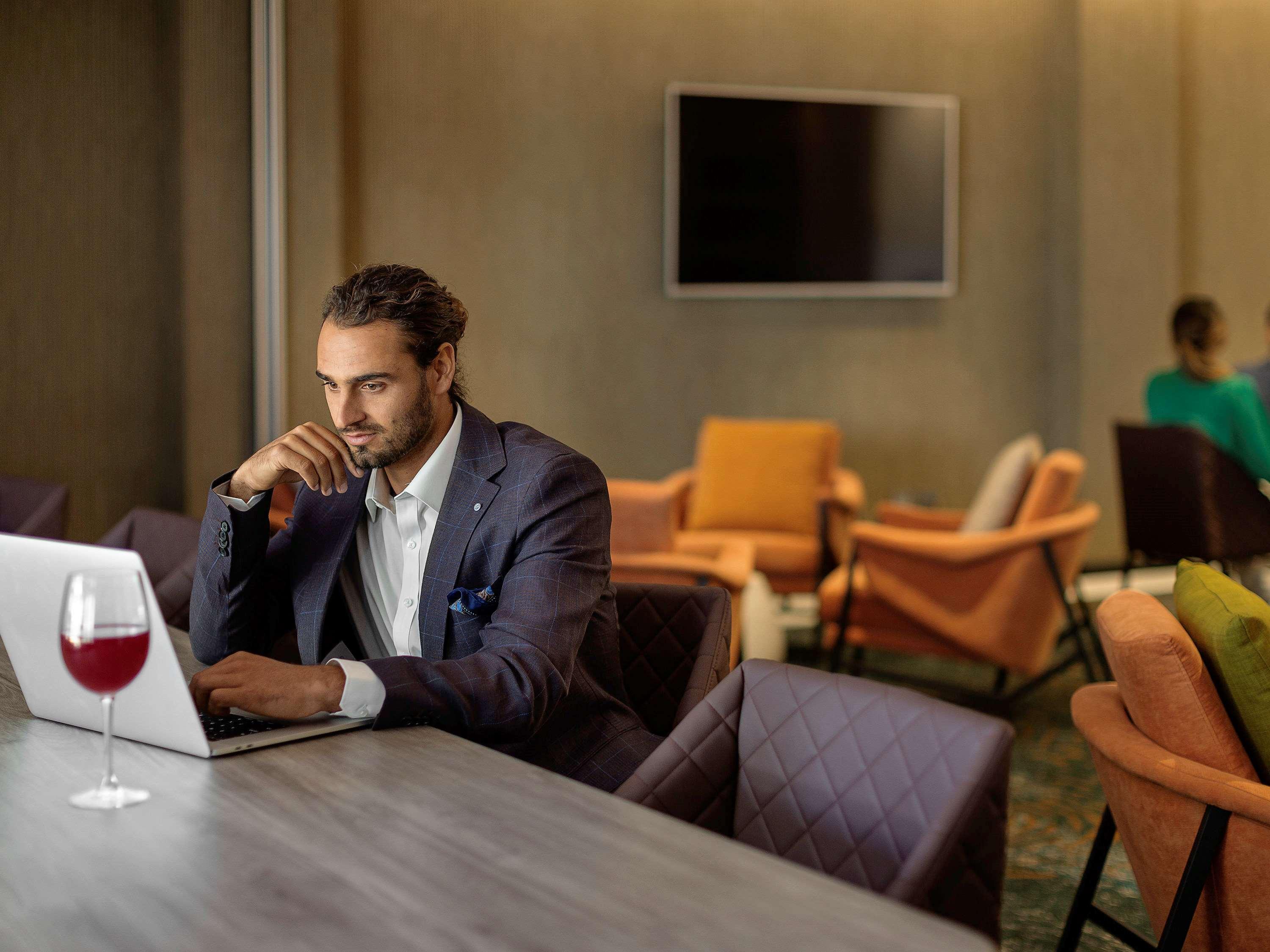 ホテル プルマン ロトルア エクステリア 写真 A man working on a laptop